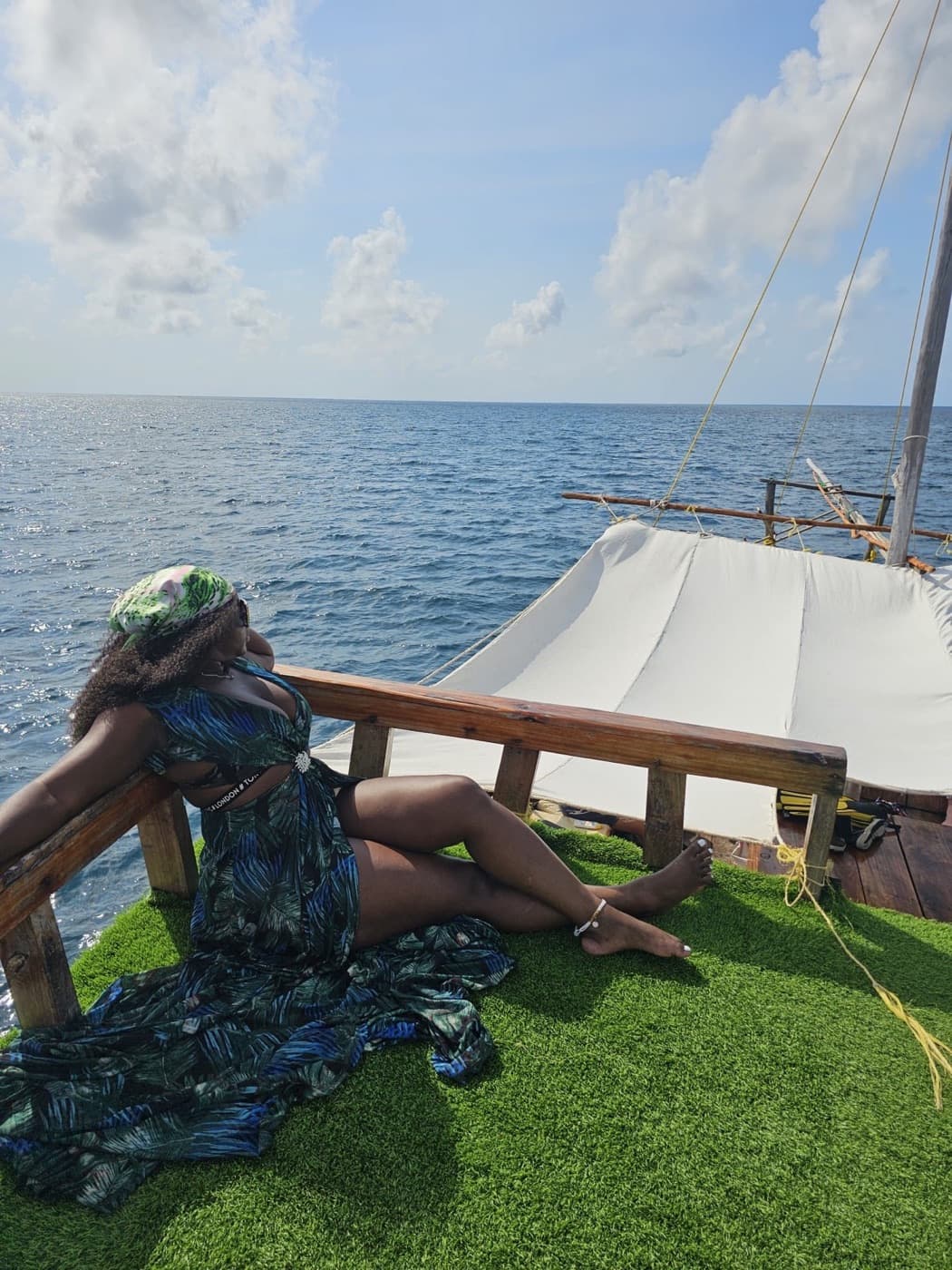 A traveler taking in the Indian Ocean from a traditional dhow