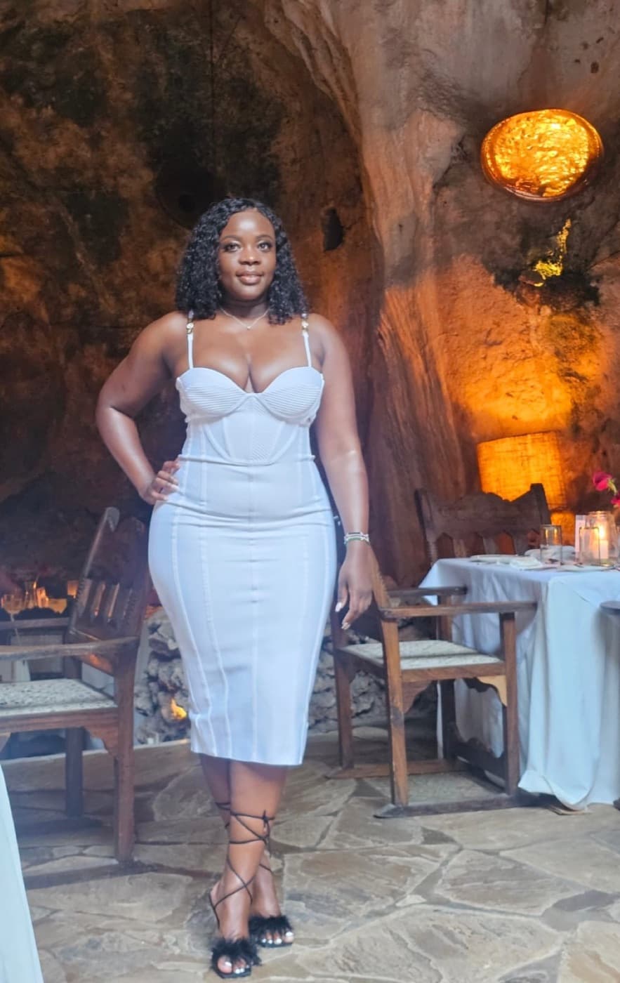 A guest dressed for a special dinner in a candlelit cave