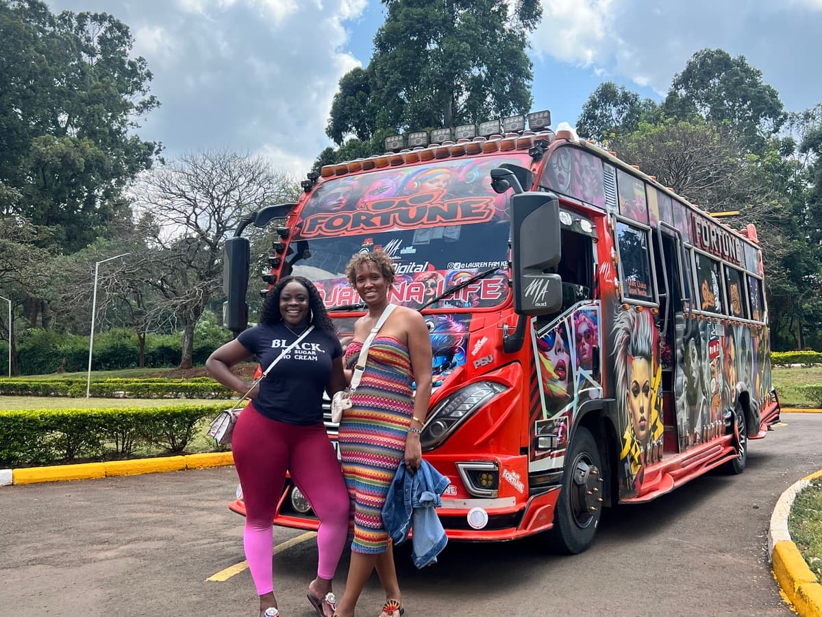 Travelers gathering beside a brightly painted matatu in Nairobi