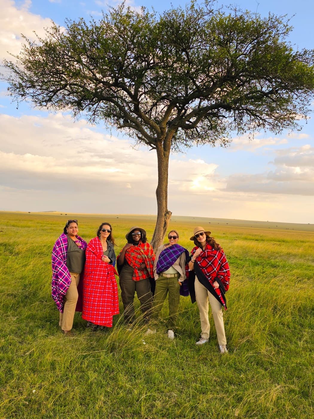 A Diaspora Roots and Routes group gathered beneath an acacia tree in Kenya